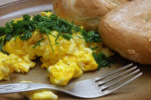 Scrambled Egg breakfast - Scrambled eggs are a quick and versatile dish that can be enjoyed for breakfast, brunch, or any meal of the day. Here's a simple guide on how to make delicious scrambled eggs:

Ingredients and Tools:
Eggs
Salt and pepper (to taste)
Butter or cooking oil
Optional additions (cheese, herbs, vegetables, etc.)
Steps:
Crack Eggs into a Bowl:

Crack the desired number of eggs into a bowl. Use a separate bowl if you plan to beat each egg individually before combining.
Beat the Eggs:

Use a fork or whisk to beat the eggs until the yolks and whites are well combined. You can add a pinch of salt and pepper at this stage for seasoning.
Preheat the Pan:

Place a non-stick skillet or frying pan over medium heat. Add a small amount of butter or cooking oil and let it melt or heat.
Pour the Beaten Eggs into the Pan:

Once the butter or oil is hot, pour the beaten eggs into the pan.
Let the Eggs Set:

Allow the eggs to sit undisturbed for a moment until the edges begin to set.
Gently Stir:

Use a spatula to gently stir the eggs, lifting and folding them from the edges towards the center. Continue stirring occasionally to create soft, moist curds.
Season and Add Extras:

Season the eggs with salt and pepper to taste. You can also add extras like cheese, herbs, or sautéed vegetables for added flavor.
Continue Cooking:

Cook the eggs to your preferred level of doneness. For creamy scrambled eggs, it's best to remove them from the heat while they are still slightly runny, as they will continue to cook from residual heat.
Serve Immediately:

Once the eggs are cooked to your liking, immediately transfer them to a plate and serve hot.
Tips for Perfect Scrambled Eggs:
Use Fresh Eggs: Fresh eggs make the best-scrambled eggs.

Low and Slow: Cook the eggs over medium-low heat to avoid overcooking and ensure a creamy texture.

Don't Overbeat: Avoid overbeating the eggs, as this can lead to dense and tough scrambled eggs.

Add Dairy: For creamier eggs, add a splash of milk, cream, or yogurt while beating the eggs.

Experiment with Add-Ins: Customize your scrambled eggs with ingredients like cheese, herbs, diced vegetables, or cooked meats.

Season Well: Season the eggs with salt and pepper to enhance their flavor.

Scrambled eggs are versatile and can be enjoyed on their own, in a sandwich, or alongside other breakfast favorites. With a few simple steps, you can create a delicious and satisfying meal.