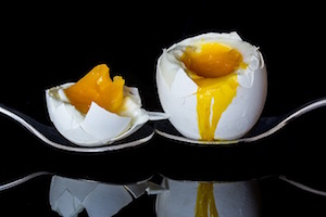 Soft boiled egg- A soft-boiled egg is an egg that has been briefly cooked in boiling water, with the egg white set while the yolk remains partially liquid. Soft-boiled eggs are a popular breakfast item and are often served with toast or as part of various dishes. Here's a simple guide on how to prepare a soft-boiled egg:

Ingredients and Tools:
Fresh eggs
Water
Pinch of salt (optional)
Steps:
Select Fresh Eggs:

Choose fresh eggs for the best results. The freshness of the eggs can affect the outcome of the soft-boiled egg.
Bring Water to a Boil:

Fill a saucepan with enough water to cover the eggs. Add a pinch of salt if desired. Bring the water to a rolling boil.
Lower the Eggs into Boiling Water:

Gently lower the eggs into the boiling water using a spoon to avoid cracking the shells.
Adjust Heat:

Once the eggs are in the water, reduce the heat to maintain a gentle simmer.
Cooking Time:

For a soft-boiled egg with a runny yolk and a set white, cook for about 4-5 minutes. Adjust the time slightly based on the size of the eggs and your preference for yolk consistency.
Use a Timer:

Set a timer to ensure you don't overcook the eggs. The timing is crucial for achieving the desired level of doneness.
Prepare an Ice Bath:

While the eggs are cooking, prepare a bowl of ice water. This will be used to stop the cooking process and cool the eggs quickly.
Transfer Eggs to Ice Bath:

Once the eggs are done cooking, use a slotted spoon to transfer them immediately to the ice bath. This helps to prevent further cooking.
Peel and Serve:

Once the eggs are cool, gently tap them on a hard surface to crack the shell, then peel the eggshell. Cut off the top of the egg and season with salt and pepper if desired. Serve with toast or use as needed in other dishes.
Soft-boiled eggs are a versatile ingredient and can be enjoyed on their own or used in various recipes. The key to achieving the perfect soft-boiled egg lies in careful timing and quickly cooling the eggs after cooking to prevent overcooking.