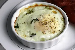 Shirred eggs, also known as baked eggs, are a delicious and easy-to-make dish where eggs are baked in individual dishes. Here's a simple guide on how to make shirred eggs:

Ingredients and Tools:
Eggs
Butter or cooking oil
Salt and pepper (to taste)
Optional toppings (cheese, herbs, cream, etc.)
Steps:
Preheat the Oven:

Preheat your oven to around 375°F (190°C).
Prepare Individual Dishes:

Grease individual oven-safe dishes or ramekins with butter or cooking oil to prevent sticking.
Crack Eggs into Dishes:

Crack one or two eggs into each prepared dish, depending on your preference and the size of the dishes.
Season Eggs:

Season the eggs with a pinch of salt and pepper to taste.
Add Toppings (Optional):

Customize your shirred eggs by adding toppings such as shredded cheese, herbs, or a drizzle of cream.
Bake in the Oven:

Place the dishes in the preheated oven and bake for about 12-15 minutes, or until the egg whites are set but the yolks are still slightly runny. Adjust the baking time based on your desired level of doneness.
Check Doneness:

Keep an eye on the eggs as they bake. The whites should be fully cooked, and the yolks can be as runny or firm as you prefer.
Serve Immediately:

Once the eggs are baked to your liking, remove them from the oven and serve immediately. The yolks can be broken and mixed with the whites if desired.
Garnish (Optional):

Garnish the shirred eggs with additional toppings such as fresh herbs, a sprinkle of cheese, or a dollop of cream before serving.
Tips for Perfect Shirred Eggs:
Use Oven-Safe Dishes: Ensure the dishes you use are safe for oven baking.

Butter the Dishes: Grease the dishes with butter or oil to prevent the eggs from sticking.

Add Toppings Creatively: Experiment with various toppings to enhance the flavor of the shirred eggs. Cheese, herbs, and cream are popular choices.

Customize Doneness: Adjust the baking time based on your preference for the doneness of the egg yolks.

Serve with Toast or Bread: Shirred eggs pair well with toast or crusty bread for a complete and satisfying breakfast.

Shirred eggs are a versatile dish that can be customized to suit your taste preferences. They make for a delightful and elegant breakfast or brunch option.